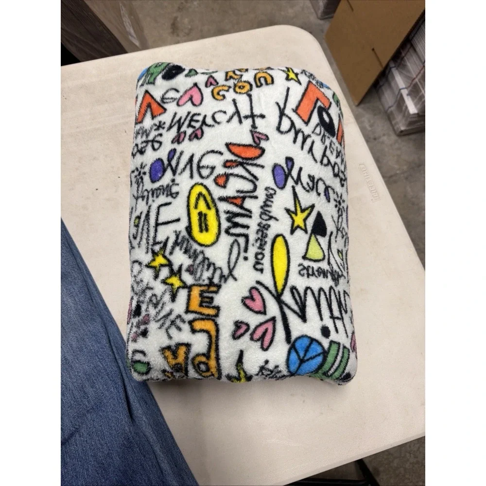 polyester throw blanket features a vibrant white graffiti print